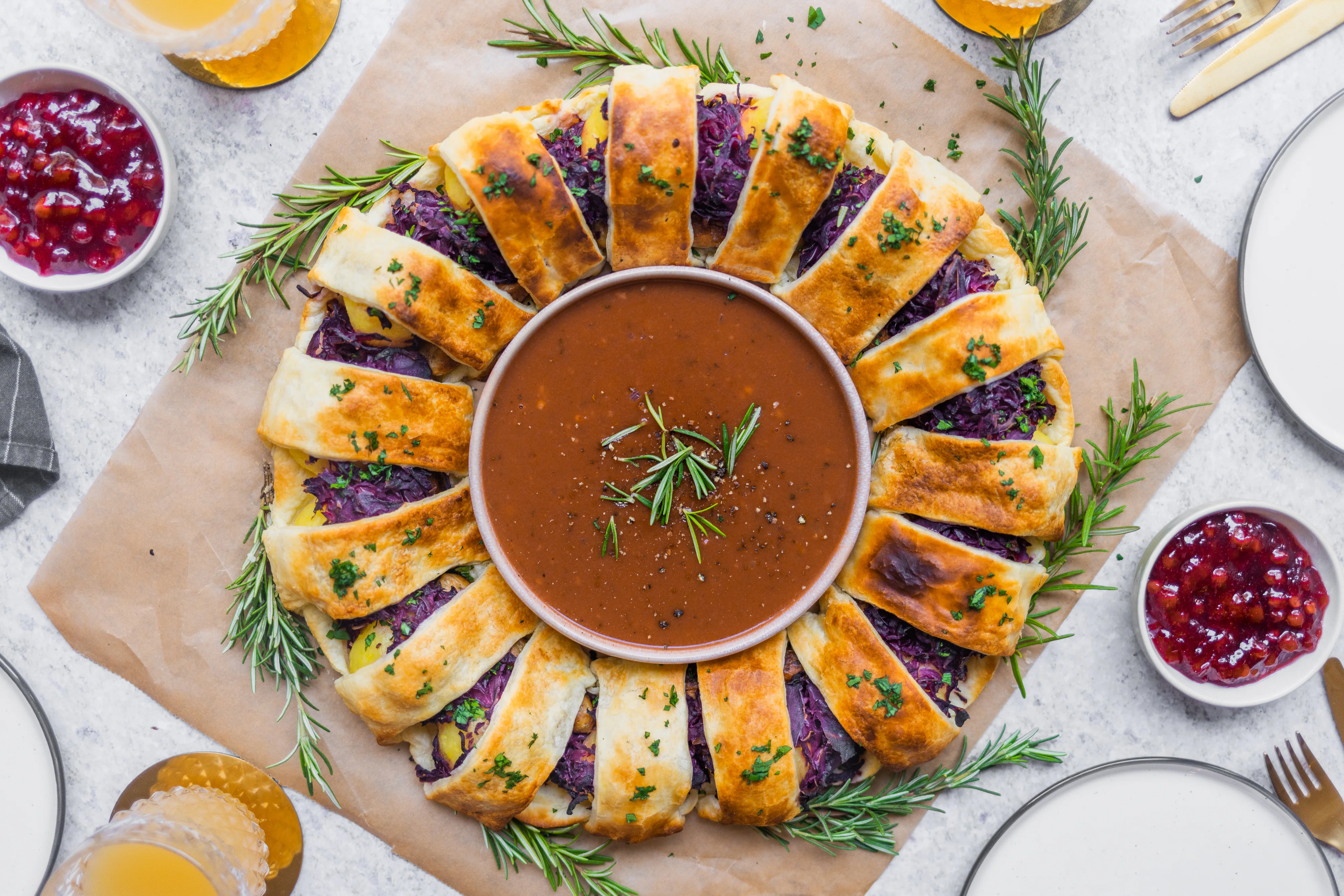 Vegan Puff Pastry Wreath Filled with Potato Dumplings, Red Cabbage & Plant-Based Sausages